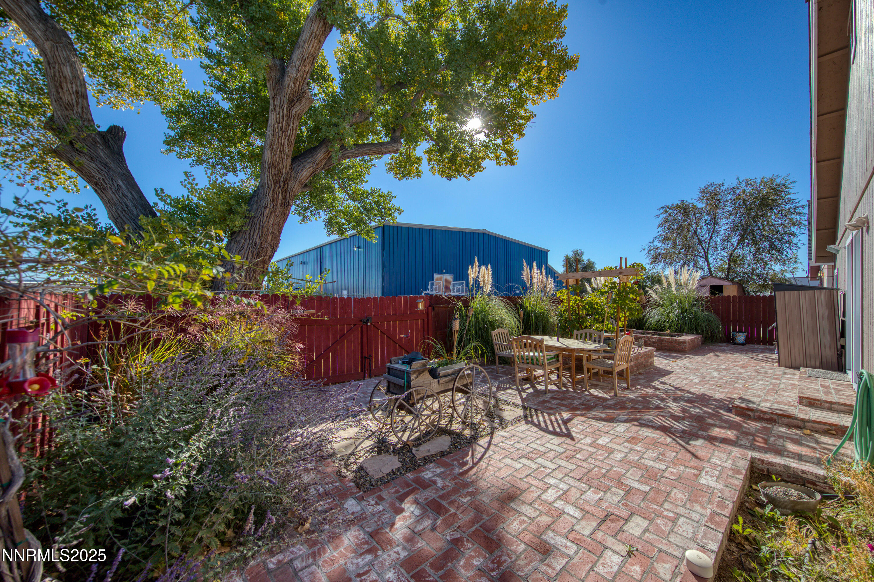 1077 Deena Way Fallon, NV 89406 - Photo 34 of 38 a view of a backyard with a table and chairs under an umbrella
