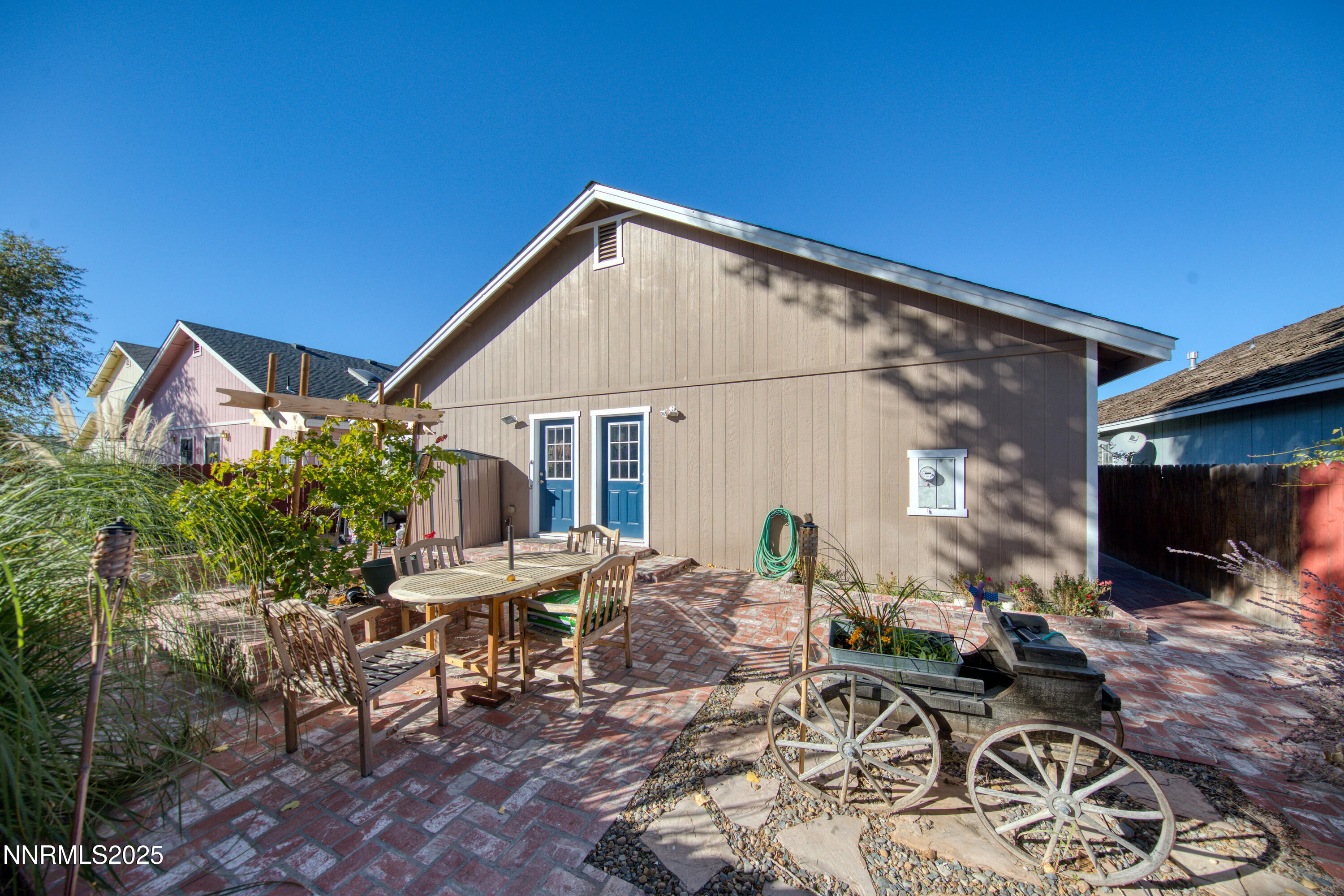 1077 Deena Way Fallon, NV 89406 - Photo 35 of 38 a view of a patio with table and chairs with wooden floor and plants