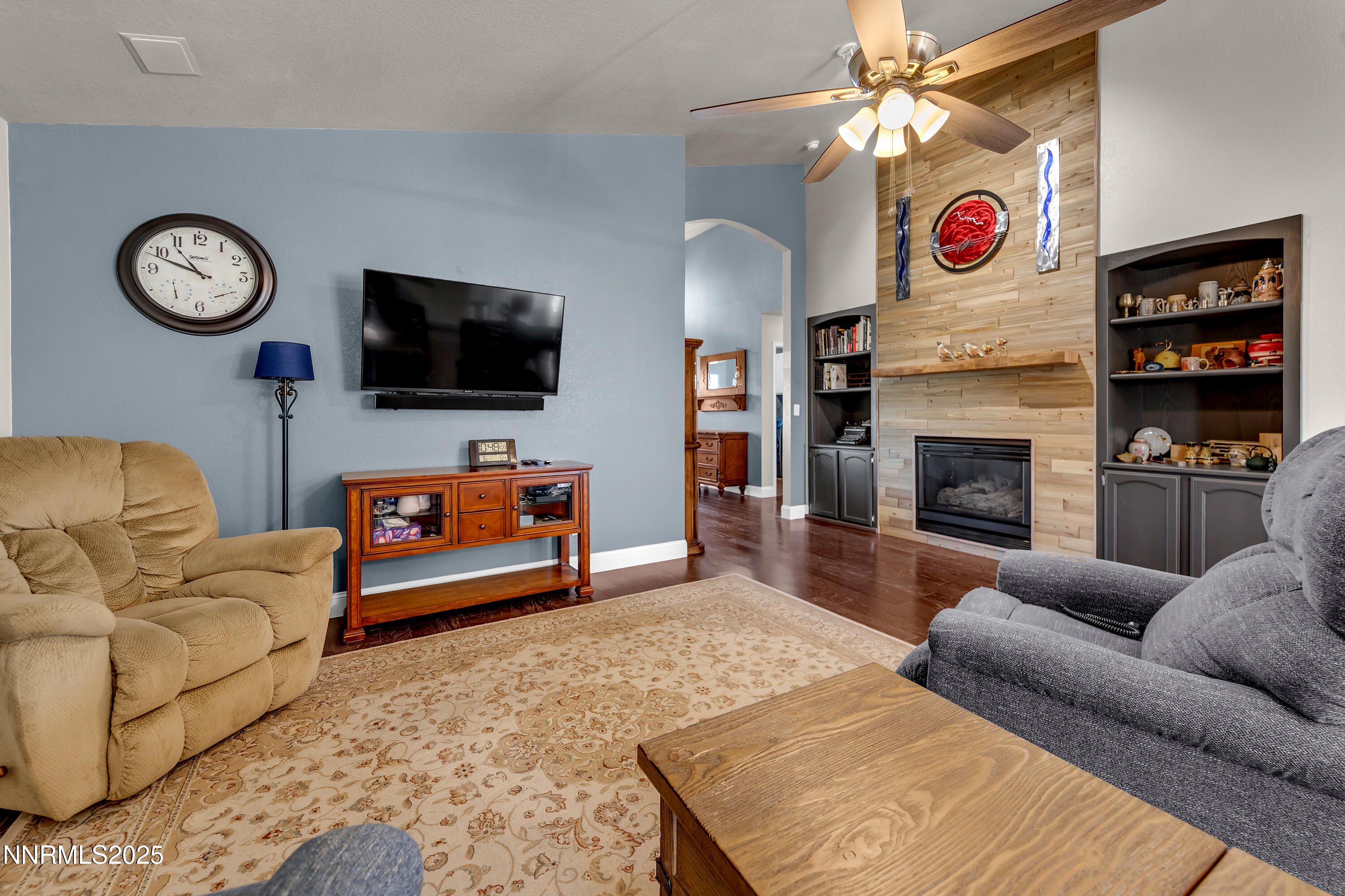 1077 Deena Way Fallon, NV 89406 - Photo 10 of 38 a living room with furniture a flat screen tv and a fireplace