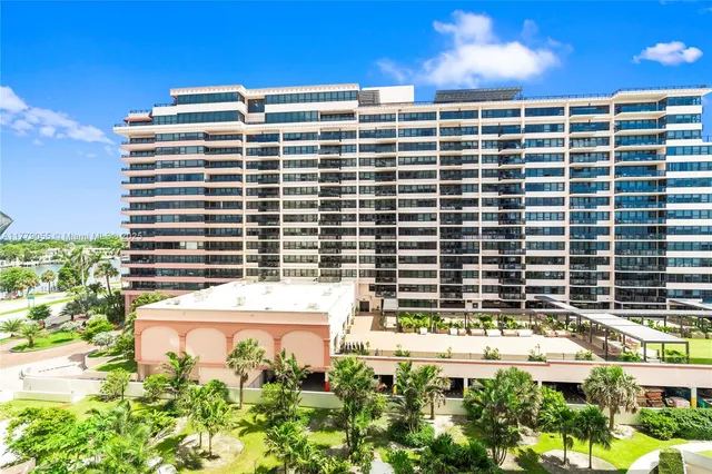 a view of a tall building next to a yard