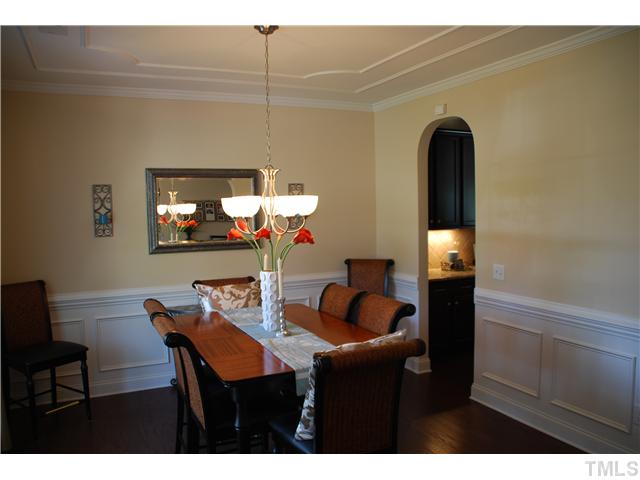 6736 Rex Road Holly Springs, NC 27540 - Photo 4 of 25 Formal dining room has lovely appointments...crown molding, chair railing and picture frame molding, just to mention a few!