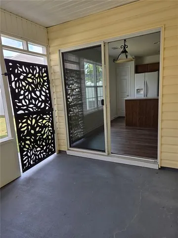 en empty room with wooden floor and windows