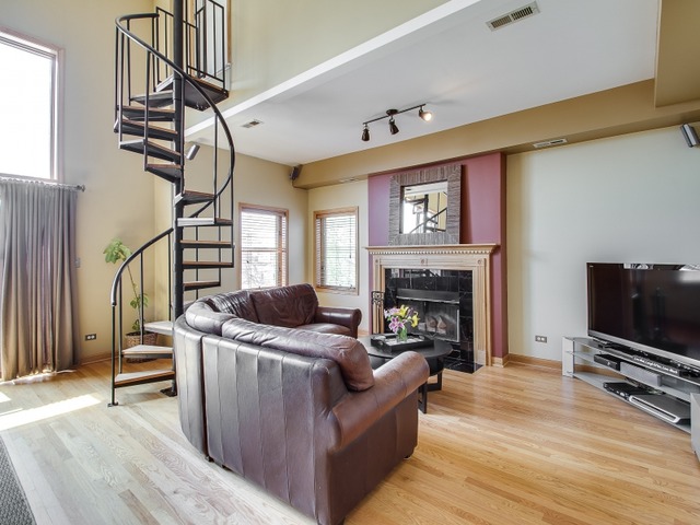1826 West Rice Street, Unit 4 Chicago, IL 60622 - Photo 3 of 25 a living room with furniture a flat screen tv and a fireplace