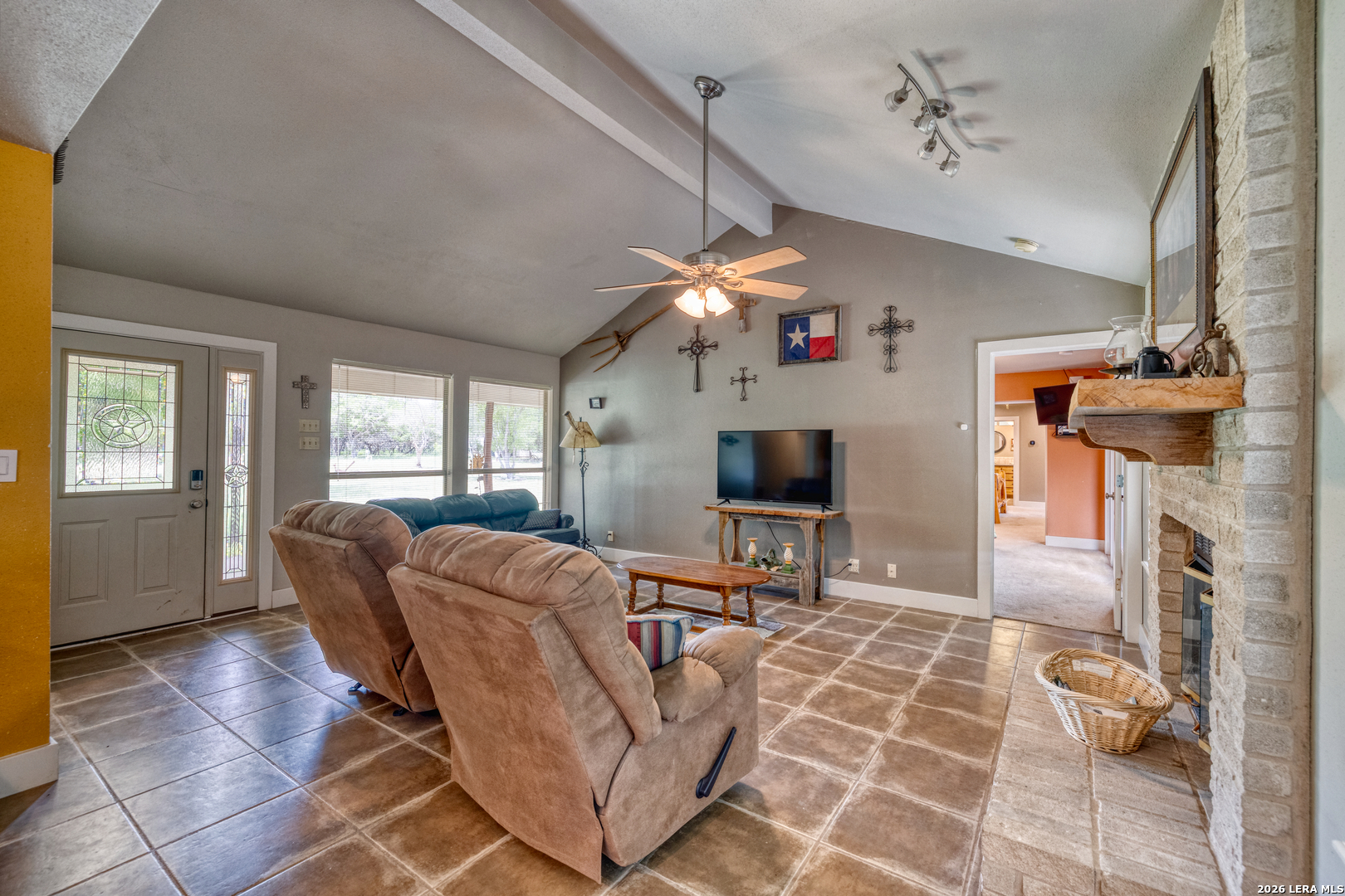 270 Robinson Road Concan, TX 78838 - Photo 24 of 50 a living room with furniture a flat screen tv and a fireplace