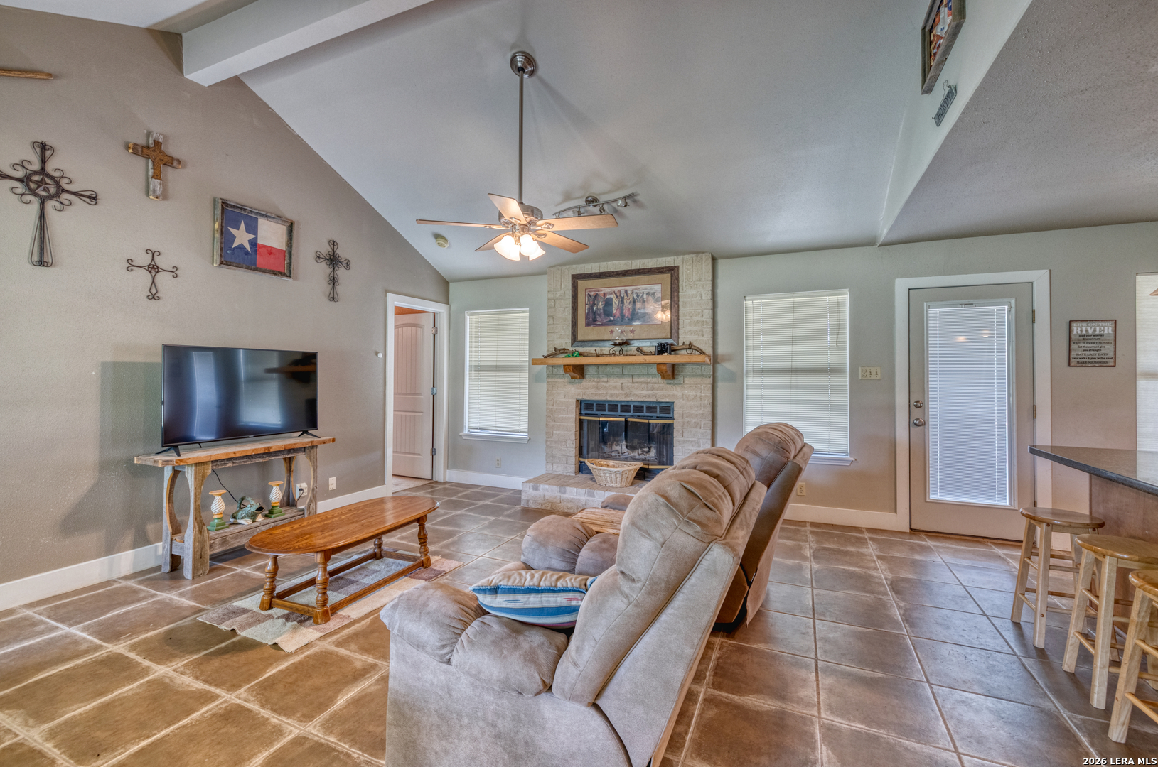 270 Robinson Road Concan, TX 78838 - Photo 25 of 50 a living room with furniture a flat screen tv and a fireplace