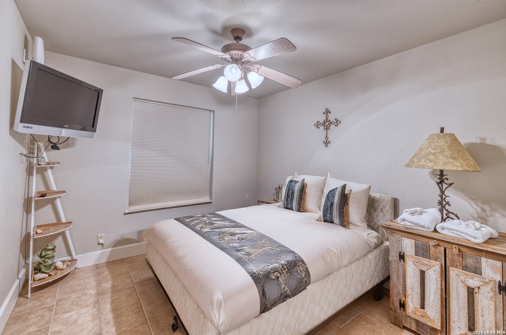 270 Robinson Road Concan, TX 78838 - Photo 26 of 50 a bedroom with a bed and a flat tv screen on dresser