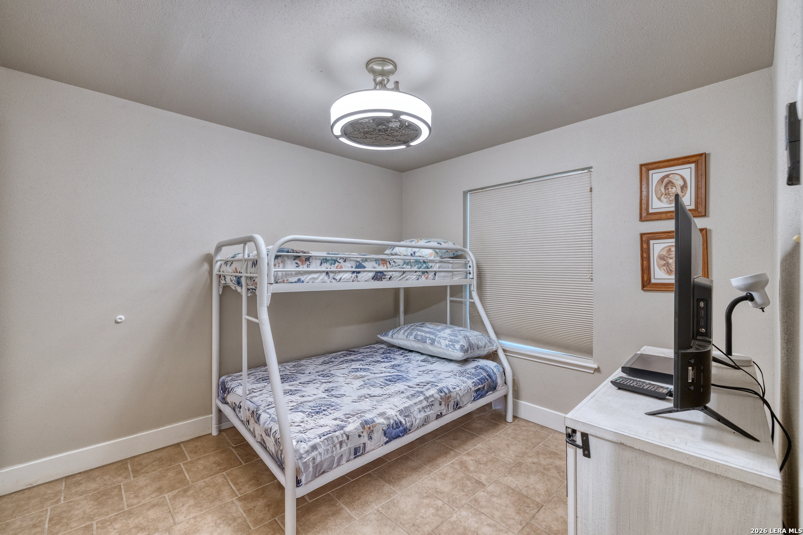 270 Robinson Road Concan, TX 78838 - Photo 28 of 50 a bedroom with a bed and a chandelier