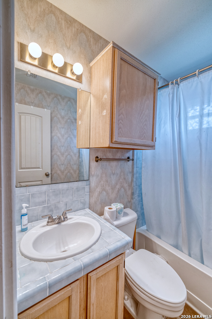 270 Robinson Road Concan, TX 78838 - Photo 29 of 50 a bathroom with a sink toilet and mirror