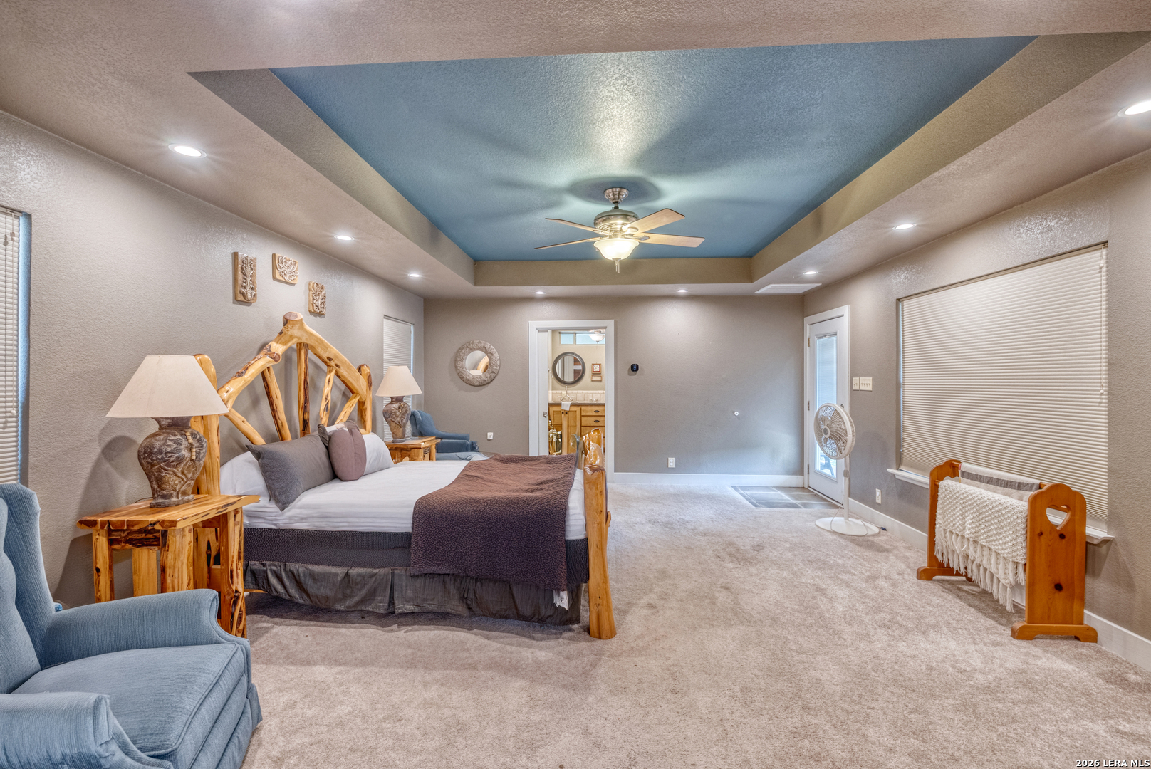 270 Robinson Road Concan, TX 78838 - Photo 33 of 50 a bedroom with a bed a couch and dresser