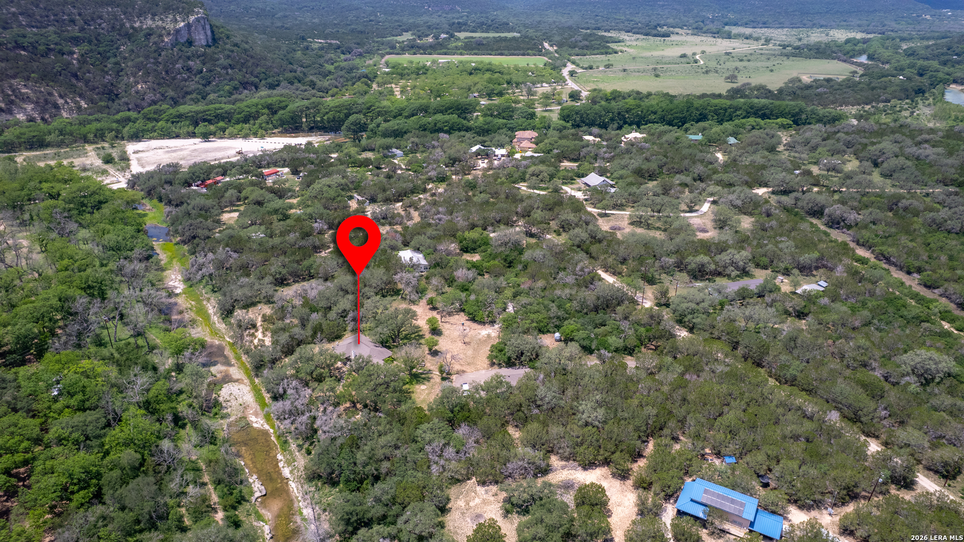 270 Robinson Road Concan, TX 78838 - Photo 43 of 50 a view of a house with a backyard