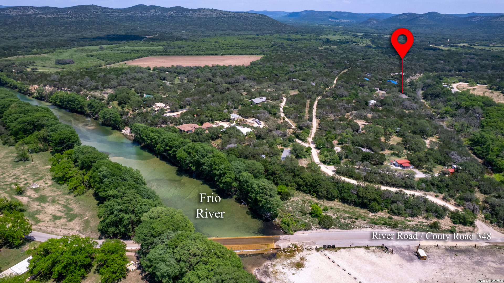 270 Robinson Road Concan, TX 78838 - Photo 47 of 50 an aerial view of a red and white house