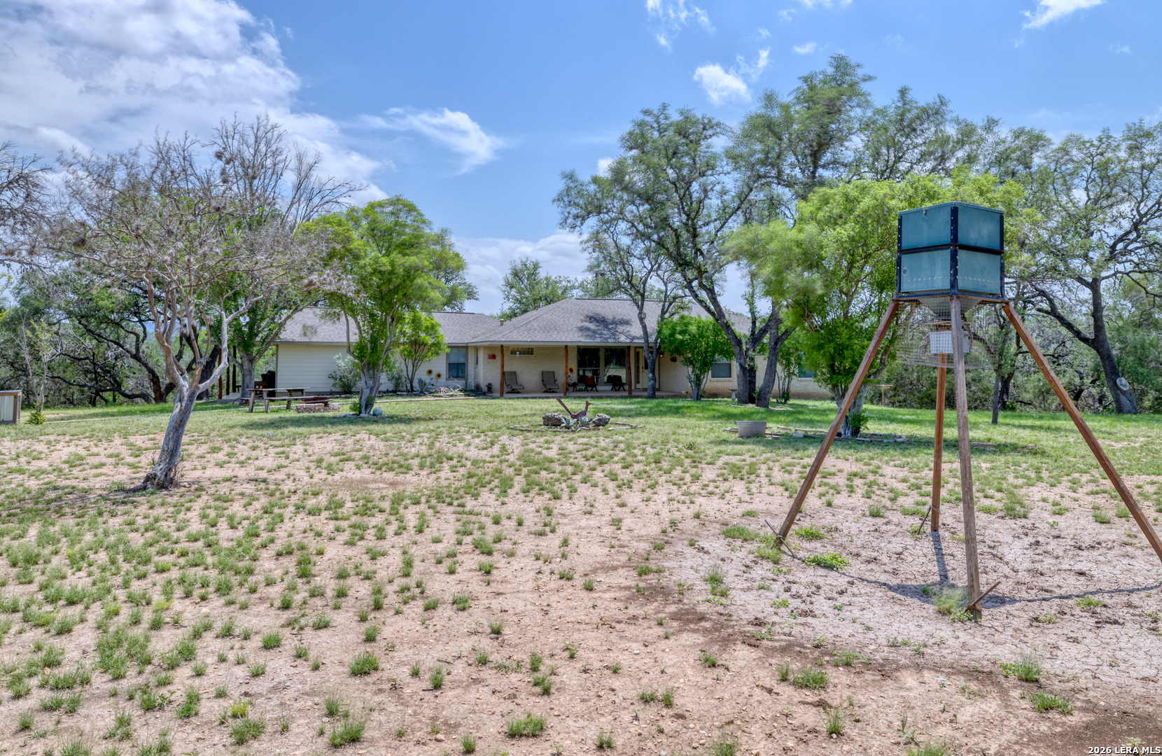 270 Robinson Road Concan, TX 78838 - Photo 6 of 50 a backyard of a house with lots of green space