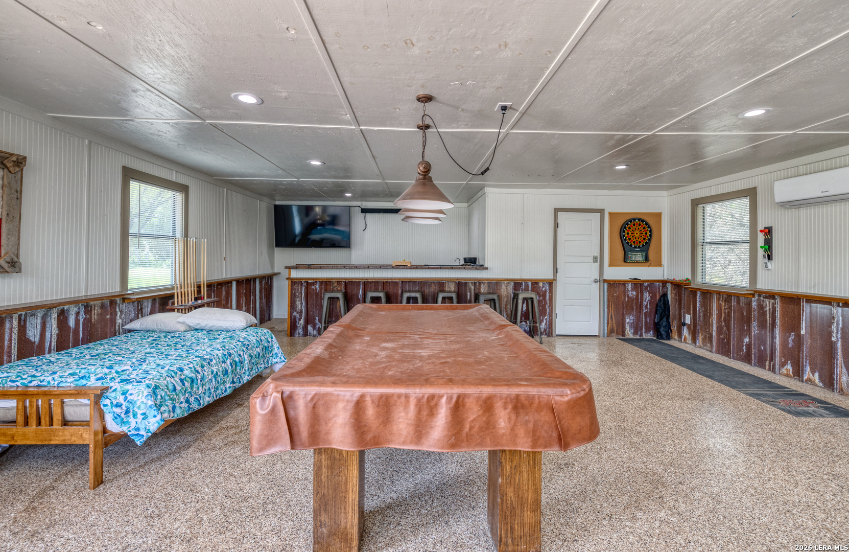 270 Robinson Road Concan, TX 78838 - Photo 8 of 50 a spacious bedroom with a bed and a chandelier