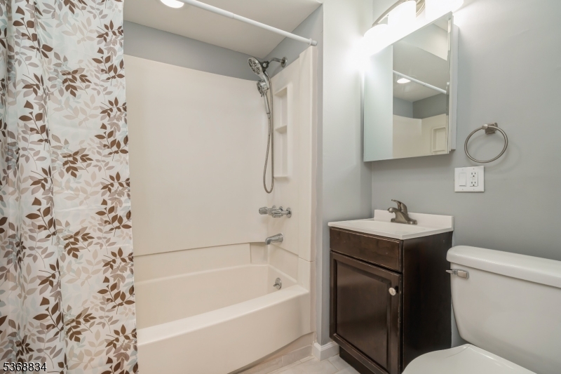 97 Allen Street, Unit 2 Netcong, NJ 07857 - Photo 20 of 29 a bathroom with a bathtub sink vanity and toilet