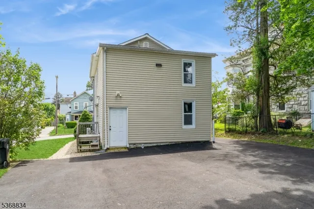 a view of a house with a yard and garage