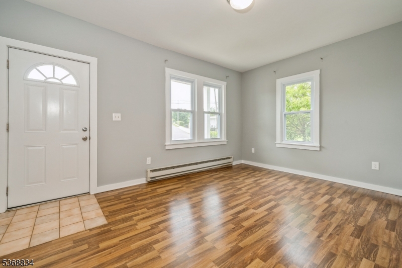 97 Allen Street, Unit 2 Netcong, NJ 07857 - Photo 4 of 29 a view of an empty room with wooden floor and a window