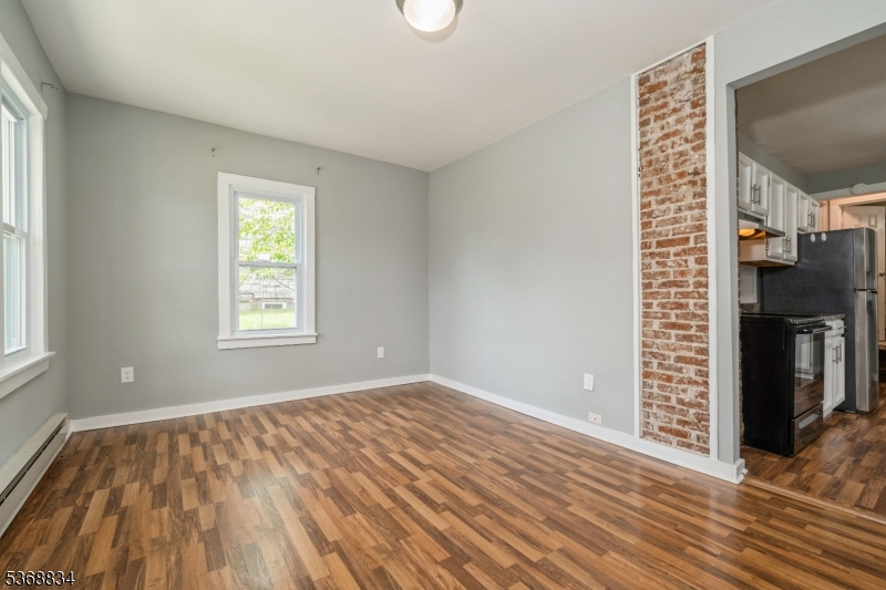 97 Allen Street, Unit 2 Netcong, NJ 07857 - Photo 6 of 29 a view of an empty room with window and wooden floor