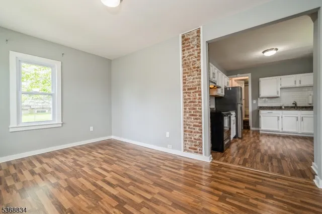 a view of a kitchen with wooden floor and a kitchen