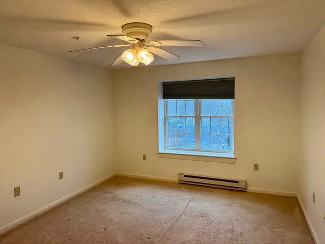 a bathroom with a granite countertop bathtub shower sink vanity and toilet