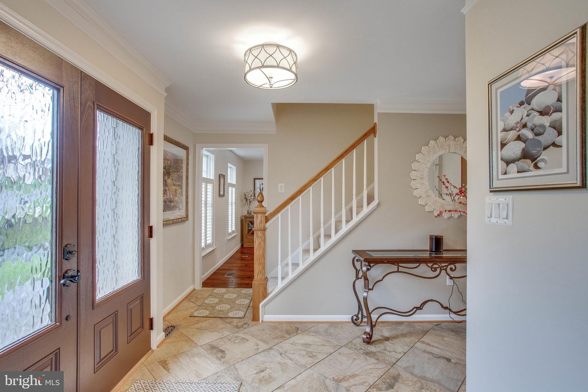 9027 Edgepark Road Vienna, VA 22182 - Photo 6 of 77 Tile foyer with on trend lighting & ceramic tile