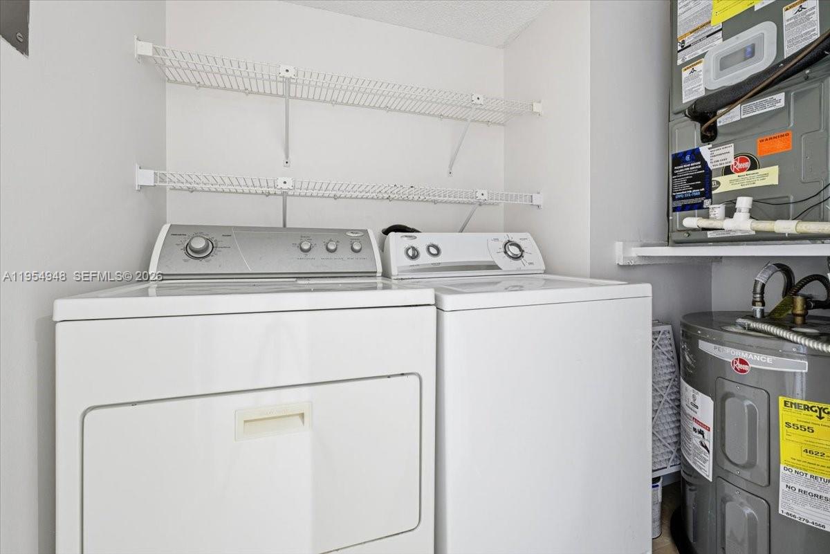 491 Racquet Club Road, Unit 107 Weston, FL 33326 - Photo 12 of 34 a utility room with dryer and washer