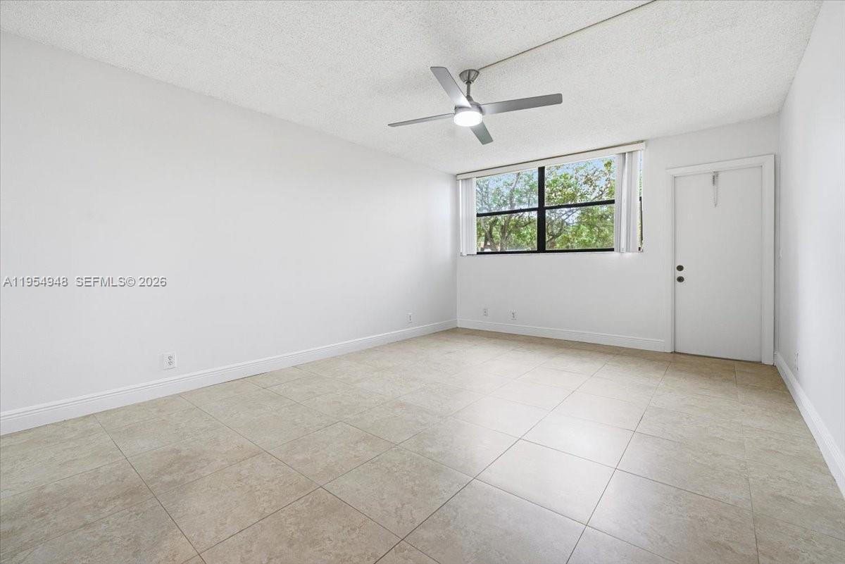 491 Racquet Club Road, Unit 107 Weston, FL 33326 - Photo 15 of 34 an empty room with windows and fan
