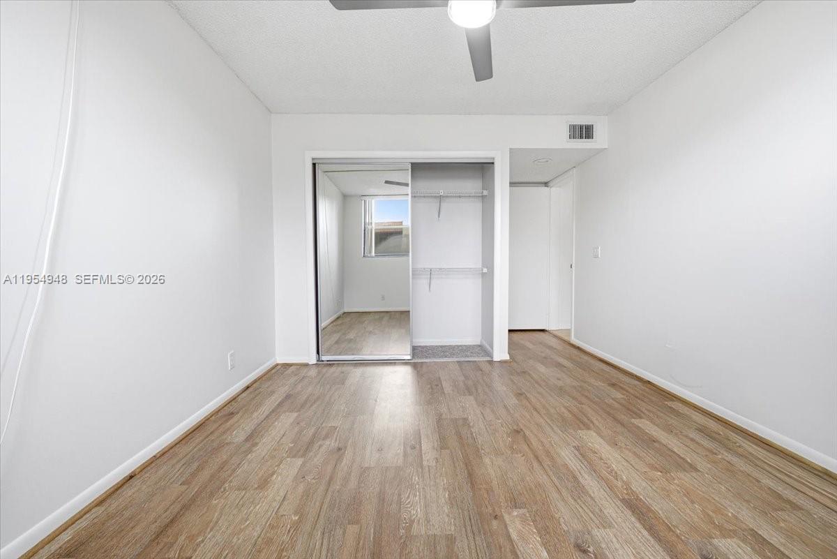 491 Racquet Club Road, Unit 107 Weston, FL 33326 - Photo 18 of 34 a view of wooden floor in an empty room