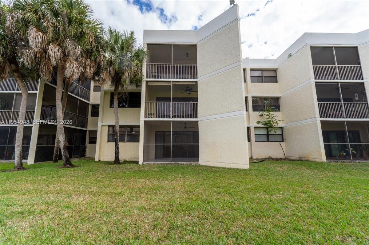 491 Racquet Club Road, Unit 107 Weston, FL 33326 - Photo 27 of 34 a view of an apartment with a large window and plants