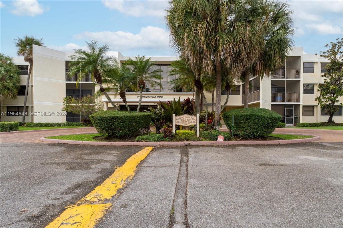 491 Racquet Club Road, Unit 107 Weston, FL 33326 - Photo 28 of 34 a view of a house with palm trees