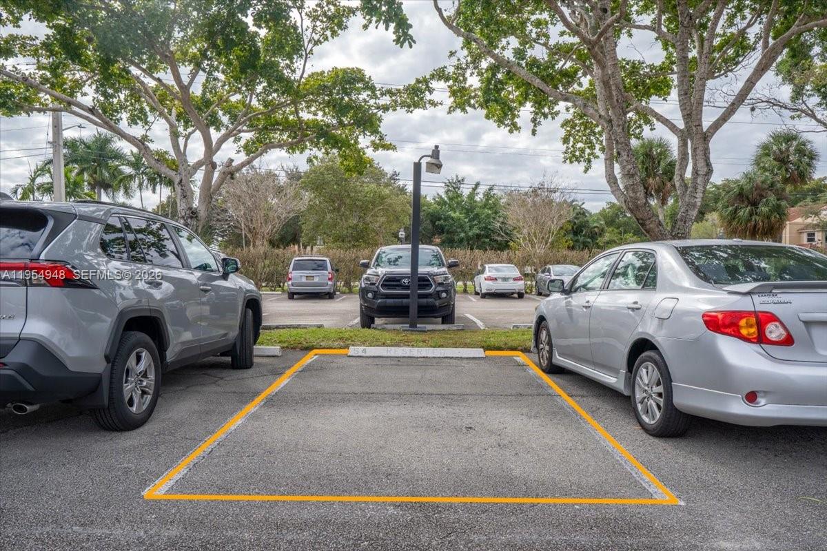 491 Racquet Club Road, Unit 107 Weston, FL 33326 - Photo 29 of 34 a view of a cars park in front of a house