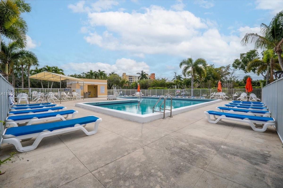 491 Racquet Club Road, Unit 107 Weston, FL 33326 - Photo 30 of 34 a view of swimming pool with outdoor seating and plants