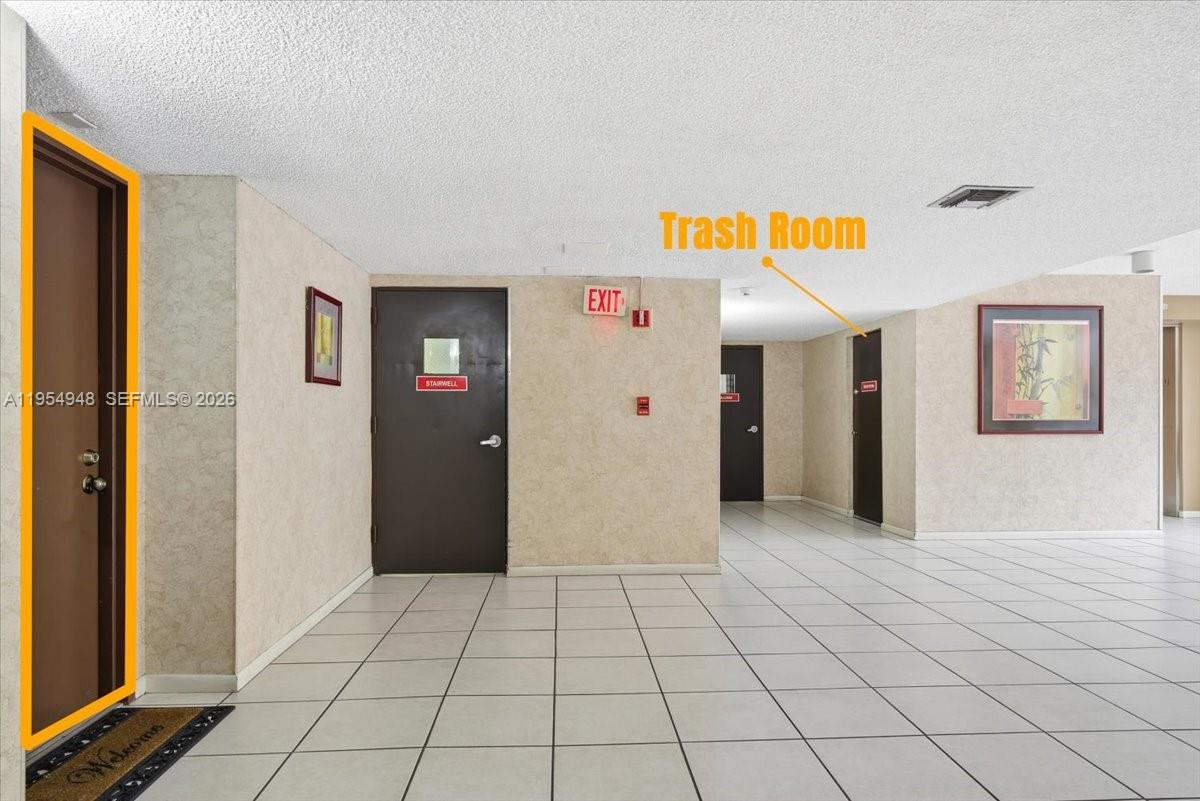 491 Racquet Club Road, Unit 107 Weston, FL 33326 - Photo 4 of 34 a view of a hallway with closet