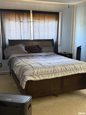 a bedroom with bed and window
