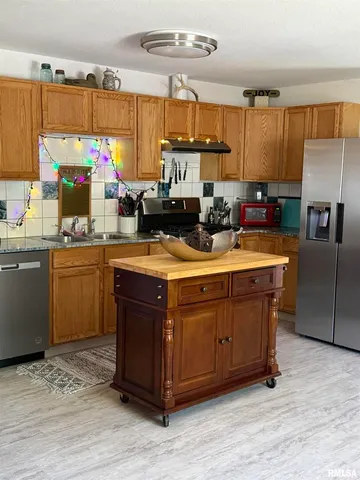 a kitchen with a sink cabinets and window