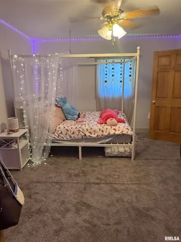 a bedroom with bed and window