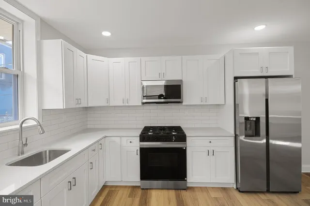 a kitchen with a refrigerator sink and microwave