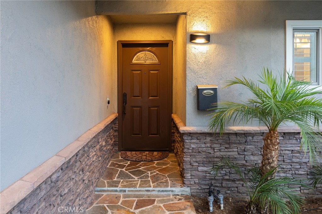 484 Traverse Drive Costa Mesa, CA 92626 - Photo 3 of 30 a potted plant sitting on a brick wall