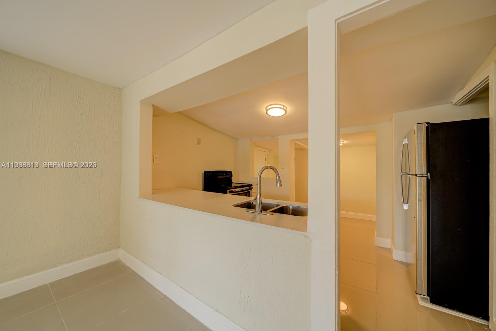 829 Northwest 56th Street Miami, FL 33127 - Photo 11 of 25 a very nice looking room with a wooden floor