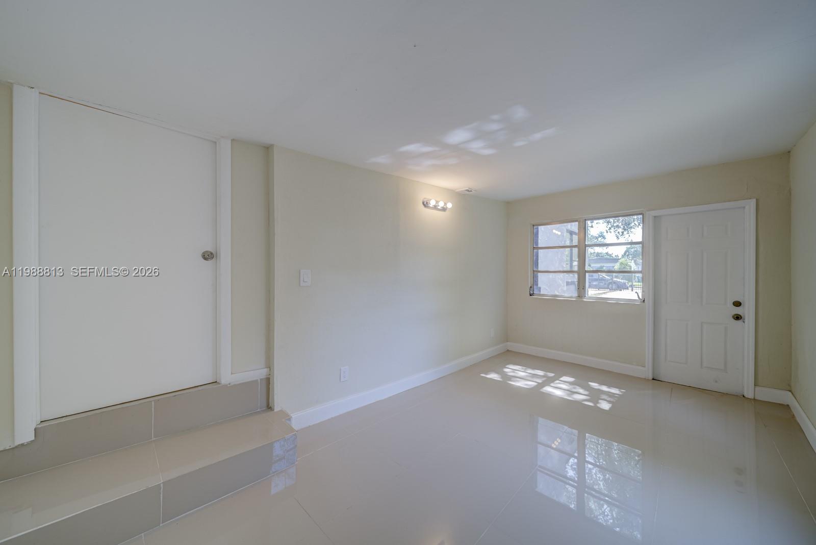 829 Northwest 56th Street Miami, FL 33127 - Photo 13 of 25 a view of an empty room with a window