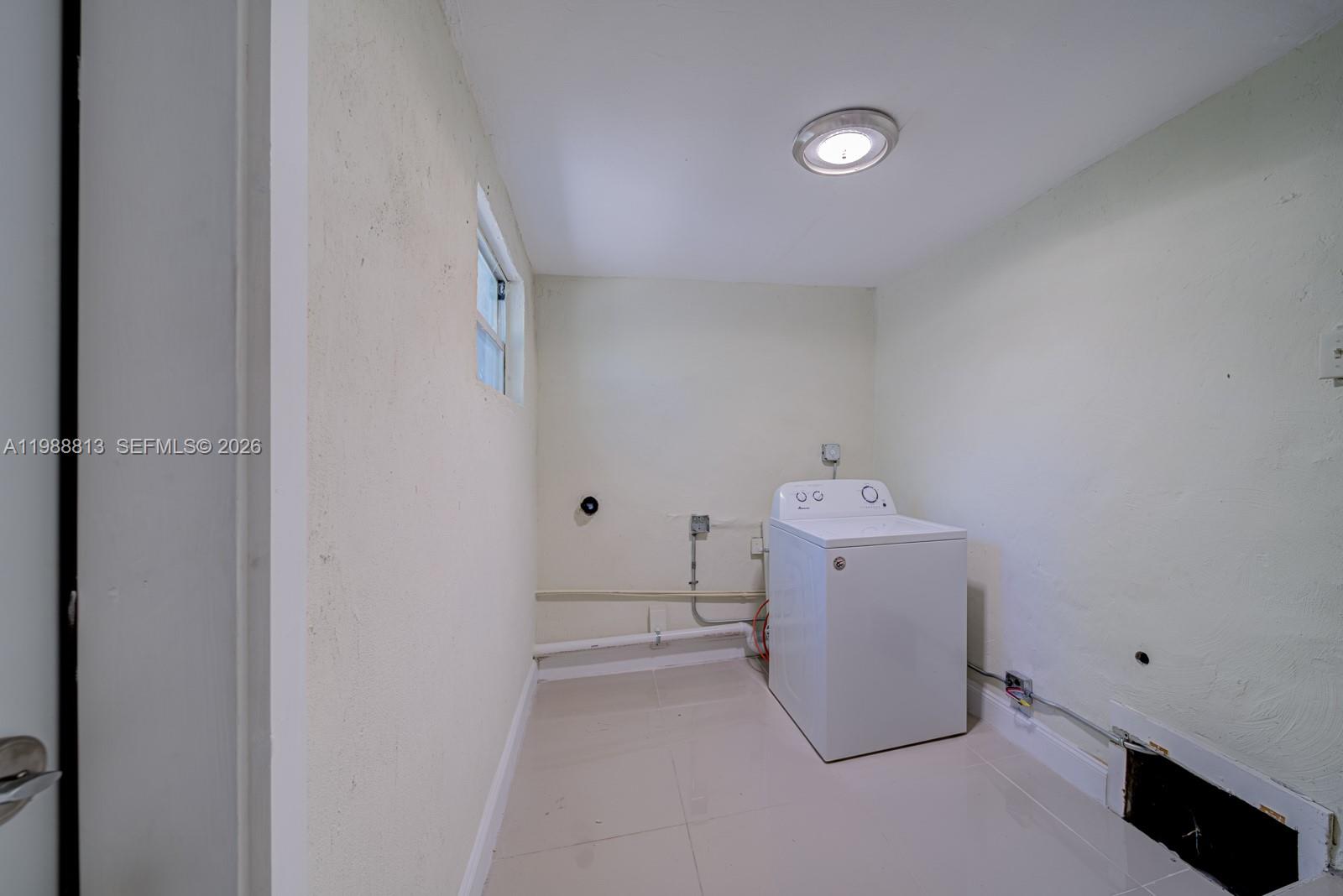 829 Northwest 56th Street Miami, FL 33127 - Photo 14 of 25 a utility room with a washer and dryer