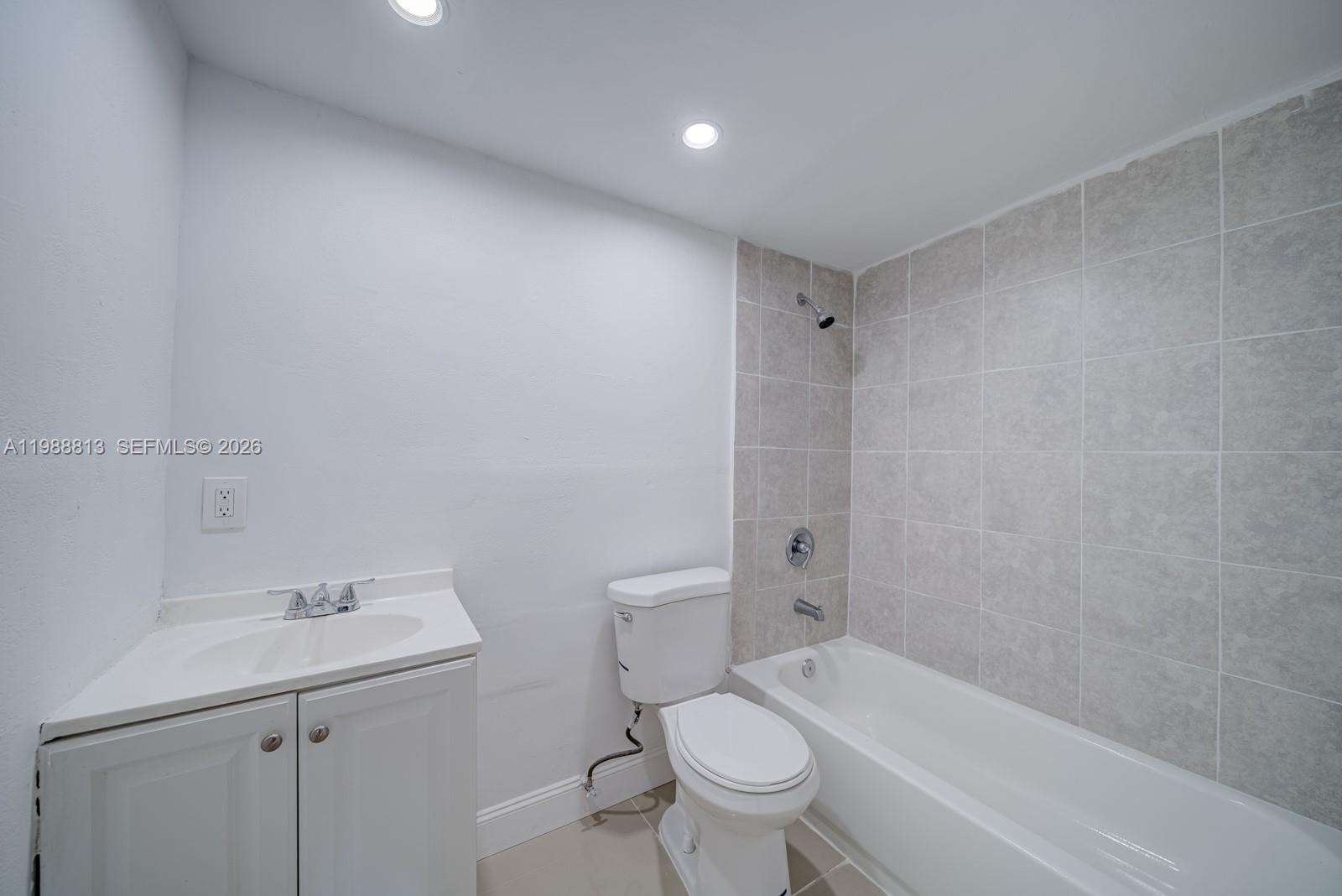 829 Northwest 56th Street Miami, FL 33127 - Photo 16 of 25 a bathroom with a sink a toilet and shower