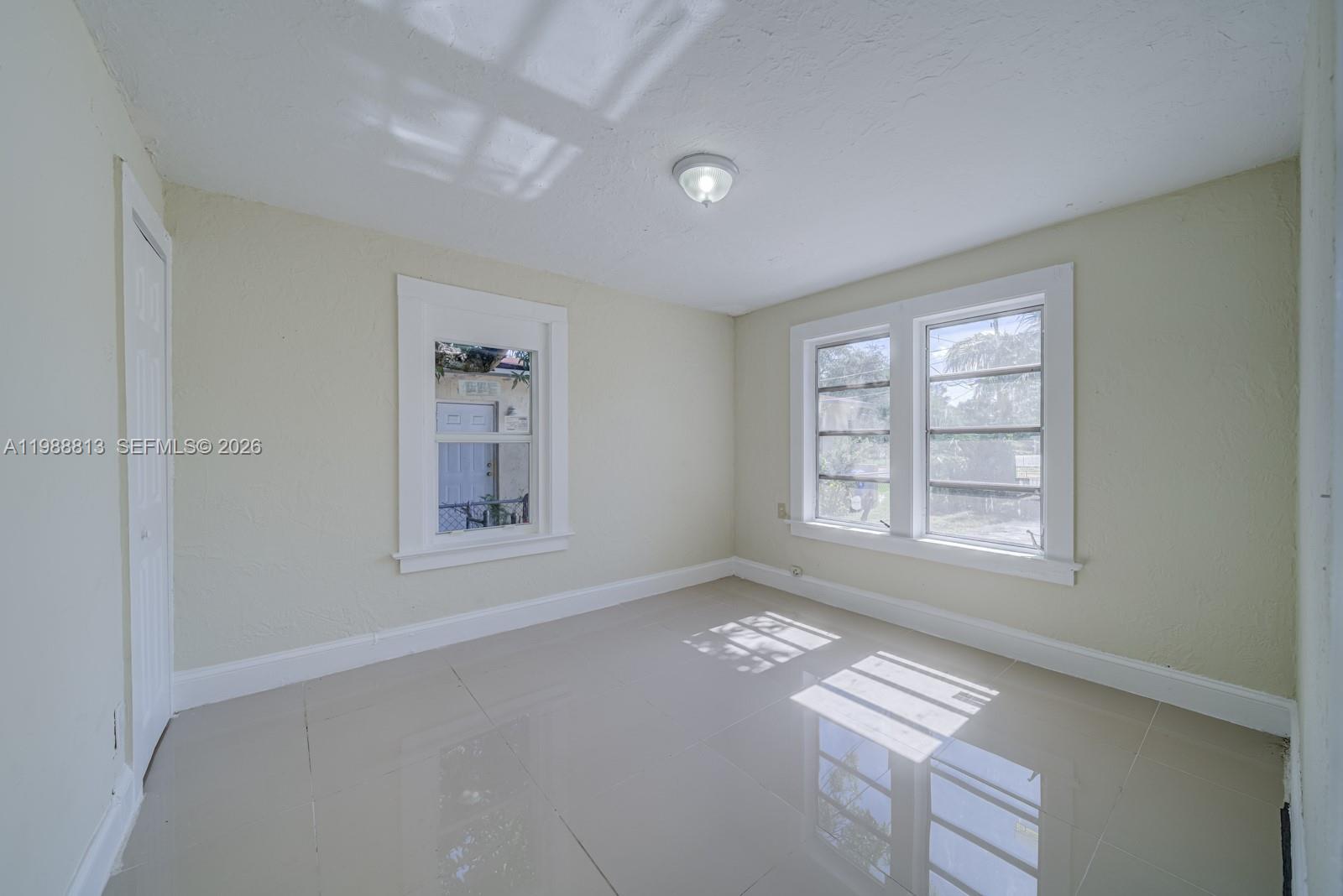829 Northwest 56th Street Miami, FL 33127 - Photo 17 of 25 a view of an empty room with a window