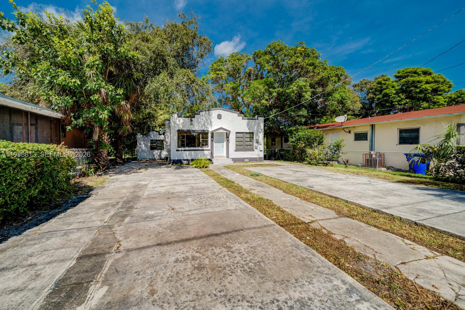 829 Northwest 56th Street Miami, FL 33127 - Photo 2 of 25 a front view of a house with a patio