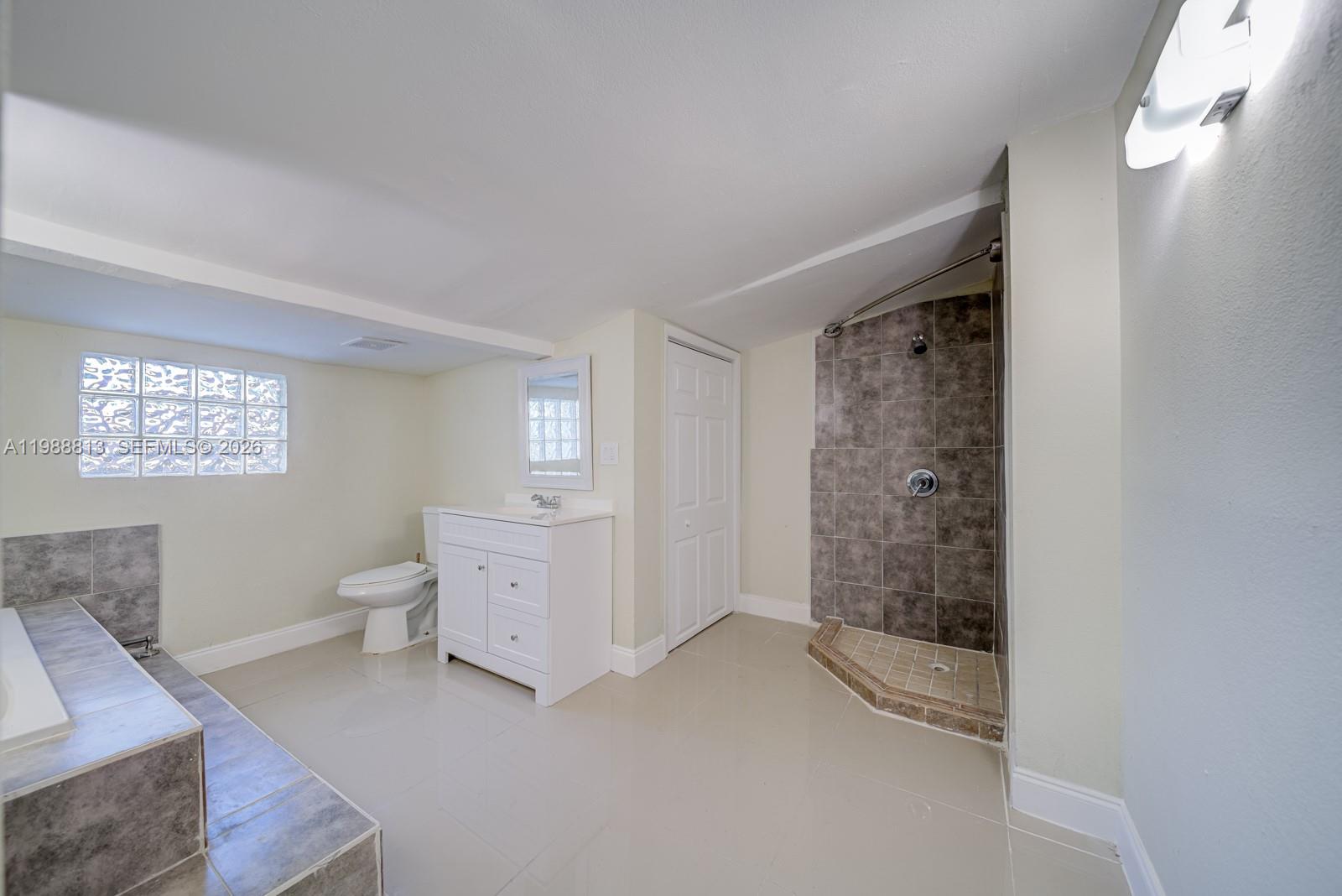 829 Northwest 56th Street Miami, FL 33127 - Photo 21 of 25 a bathroom with a toilet sink and shower
