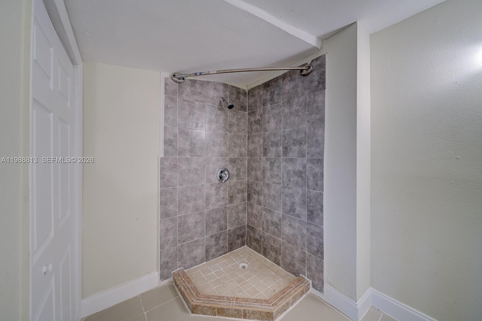 829 Northwest 56th Street Miami, FL 33127 - Photo 22 of 25 a bathroom with a shower and a toilet