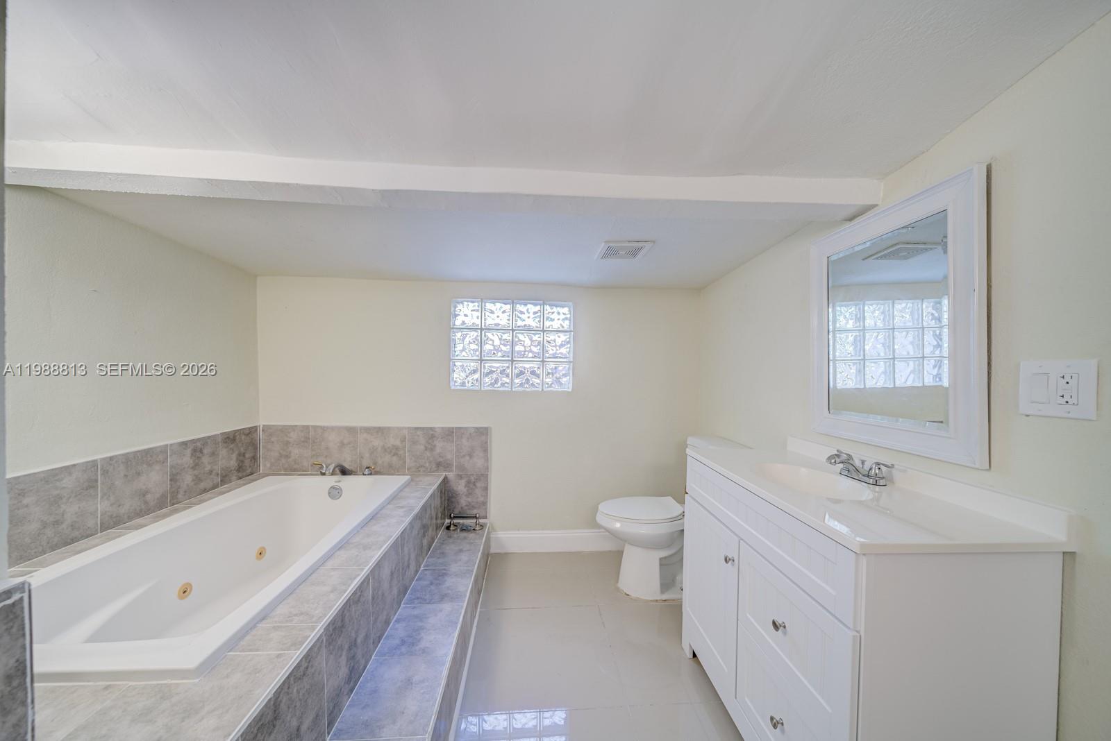 829 Northwest 56th Street Miami, FL 33127 - Photo 23 of 25 a bathroom with a bathtub and a sink