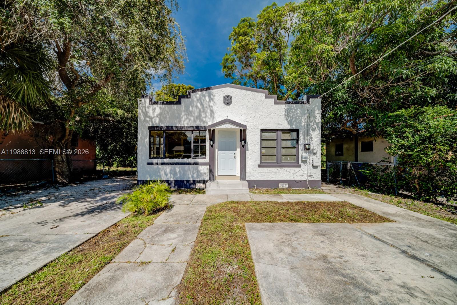829 Northwest 56th Street Miami, FL 33127 - Photo 4 of 25 a front view of a house with a yard