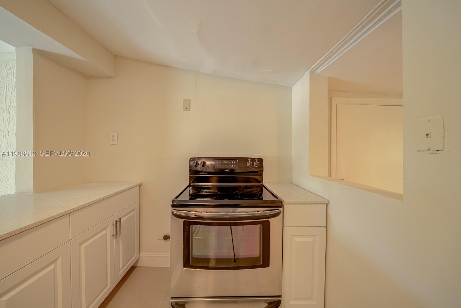 829 Northwest 56th Street Miami, FL 33127 - Photo 7 of 25 a view of kitchen and stove