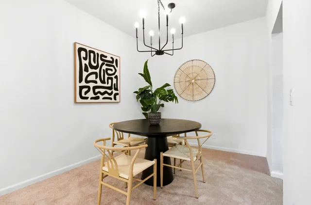 a dining room with furniture and window