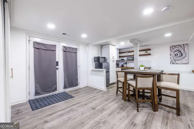 a view of a dining room with furniture and wooden floor